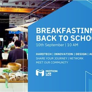 Group of people having breakfast and talk about tech at MotionLab.Berlin
